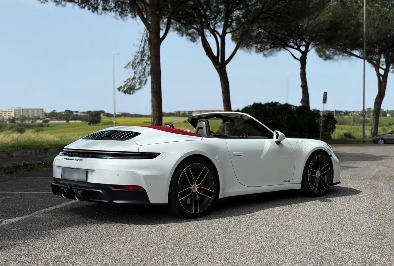 Porsche 992.2 Carrera 4 GTS Cabrio 2025, front view — Sports Car Rental Germany, Germany. Top down for Alpine passes at golden hour