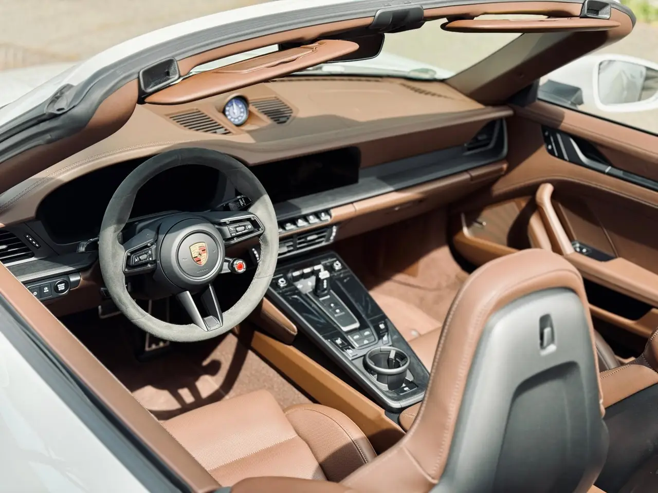 Porsche 992.2 Carrera 4 GTS Cabrio 2025, interior — Sports Car Rental Germany, Germany. Top down for Alpine passes at golden hour