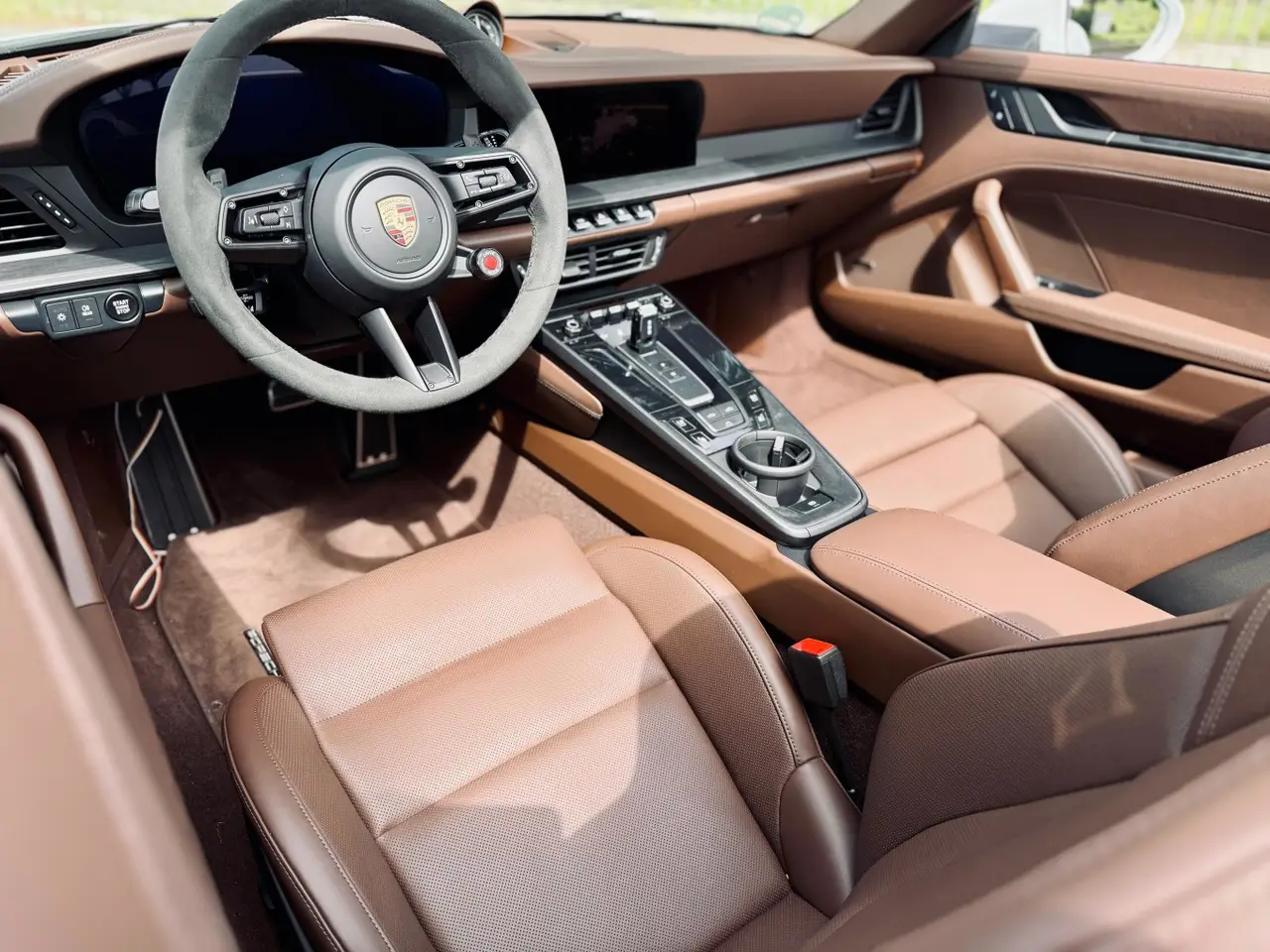 Porsche 992.2 Carrera 4 GTS Cabrio 2025, dashboard — Sports Car Rental Germany, Germany. Top down for Alpine passes at golden hour